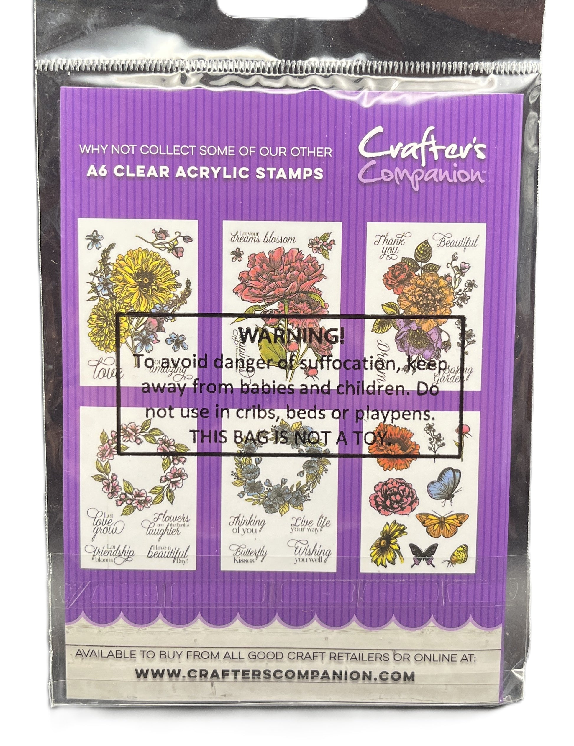 Packaged clear acrylic stamps with floral designs on a purple background, featuring the brand 'Crafters Companion'.