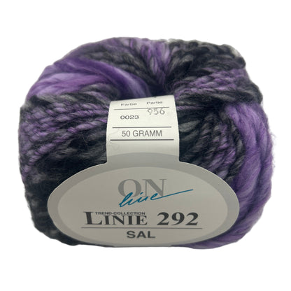 Ball of purple and black yarn with a label on a white background