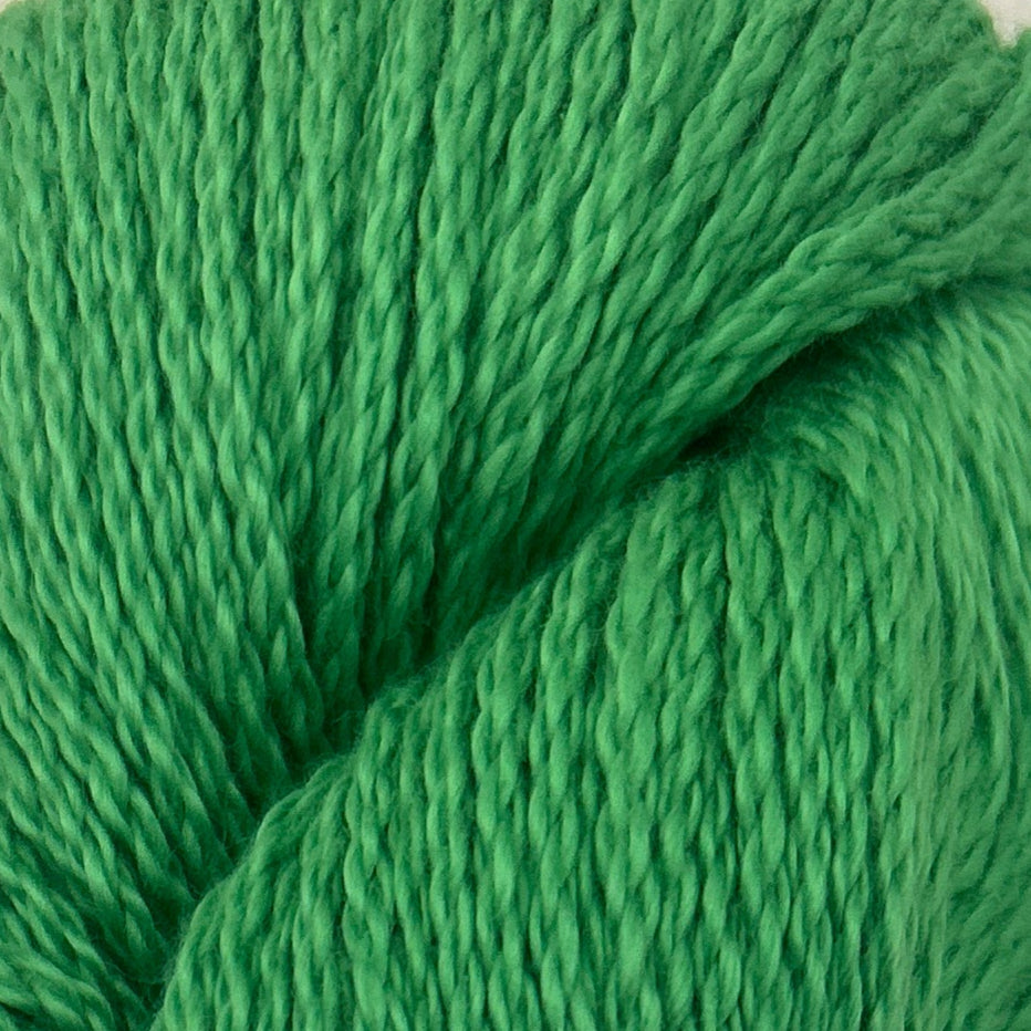 Green skein of yarn with a blue label on a light gray background