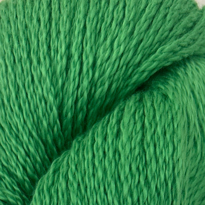 Green skein of yarn with a blue label on a light gray background