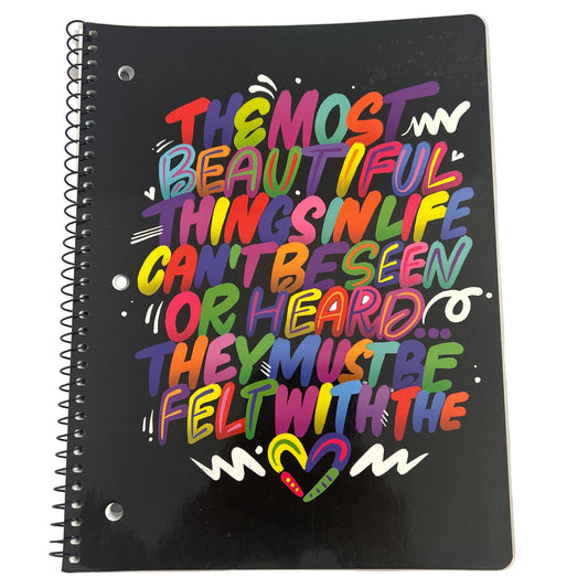 Black notebook with colorful text design on a white background
