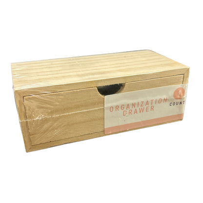 Wooden stamp block with a label on a dark surface