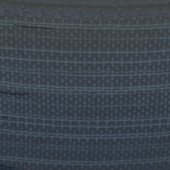 Close-up of a textured blue fabric with a subtle pattern