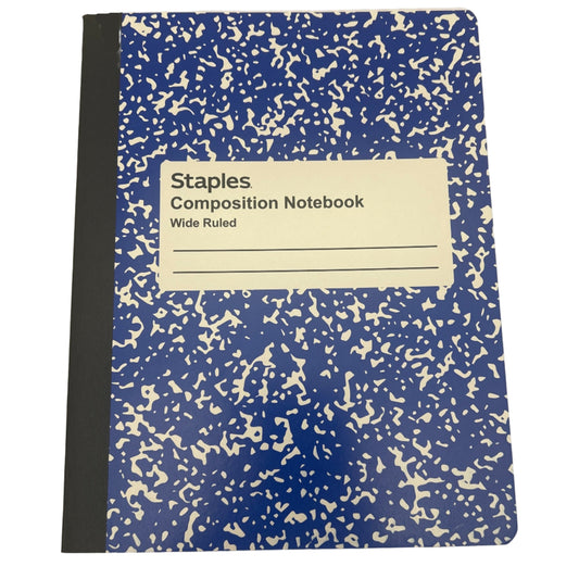 Staples composition notebook with blue cover and white speckles on a white background