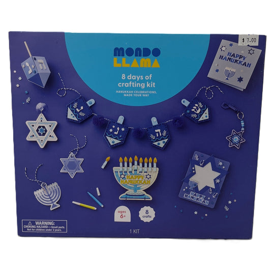 Mondo Llama Hanukkah crafting kit packaging with various craft items on a blue background