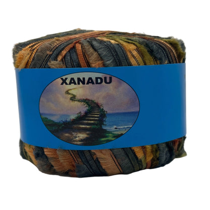 Multicolored yarn ball with a blue label featuring the brand 'Xanadu'.