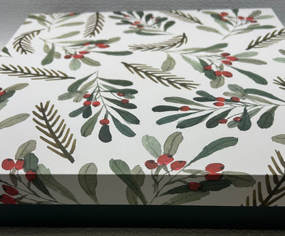 Wrinkled paper with holly leaf and berry pattern on a white background