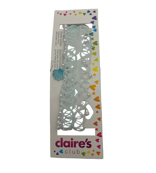 Decorative paper cutouts with colorful heart shapes in a Claire's Club packaging on a white background