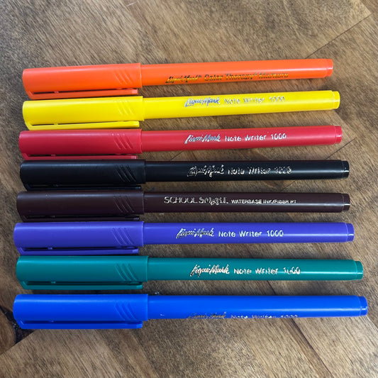 Set of colorful felt-tip pens on a wooden surface