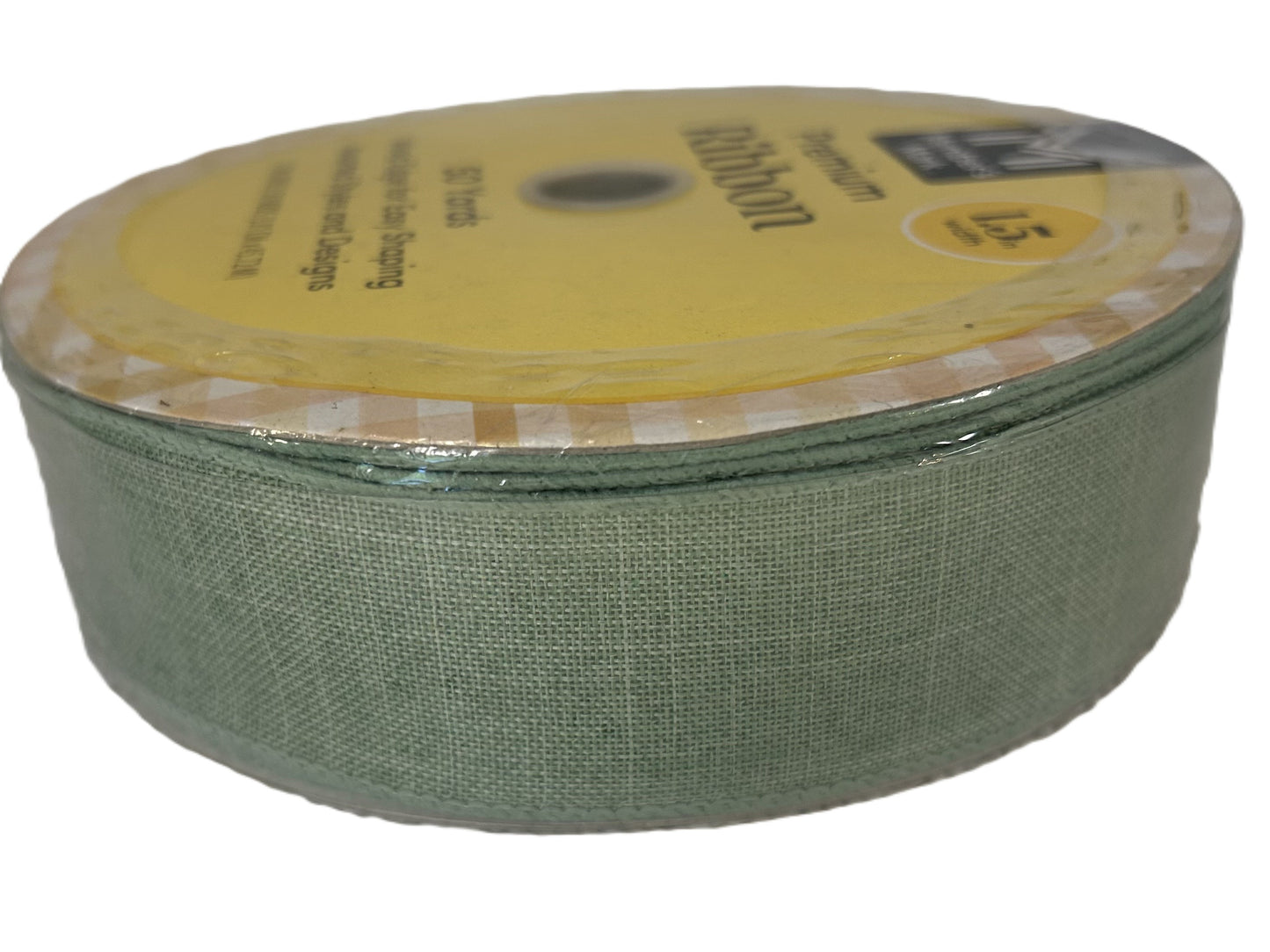 Green ribbon on a spool with a yellow label