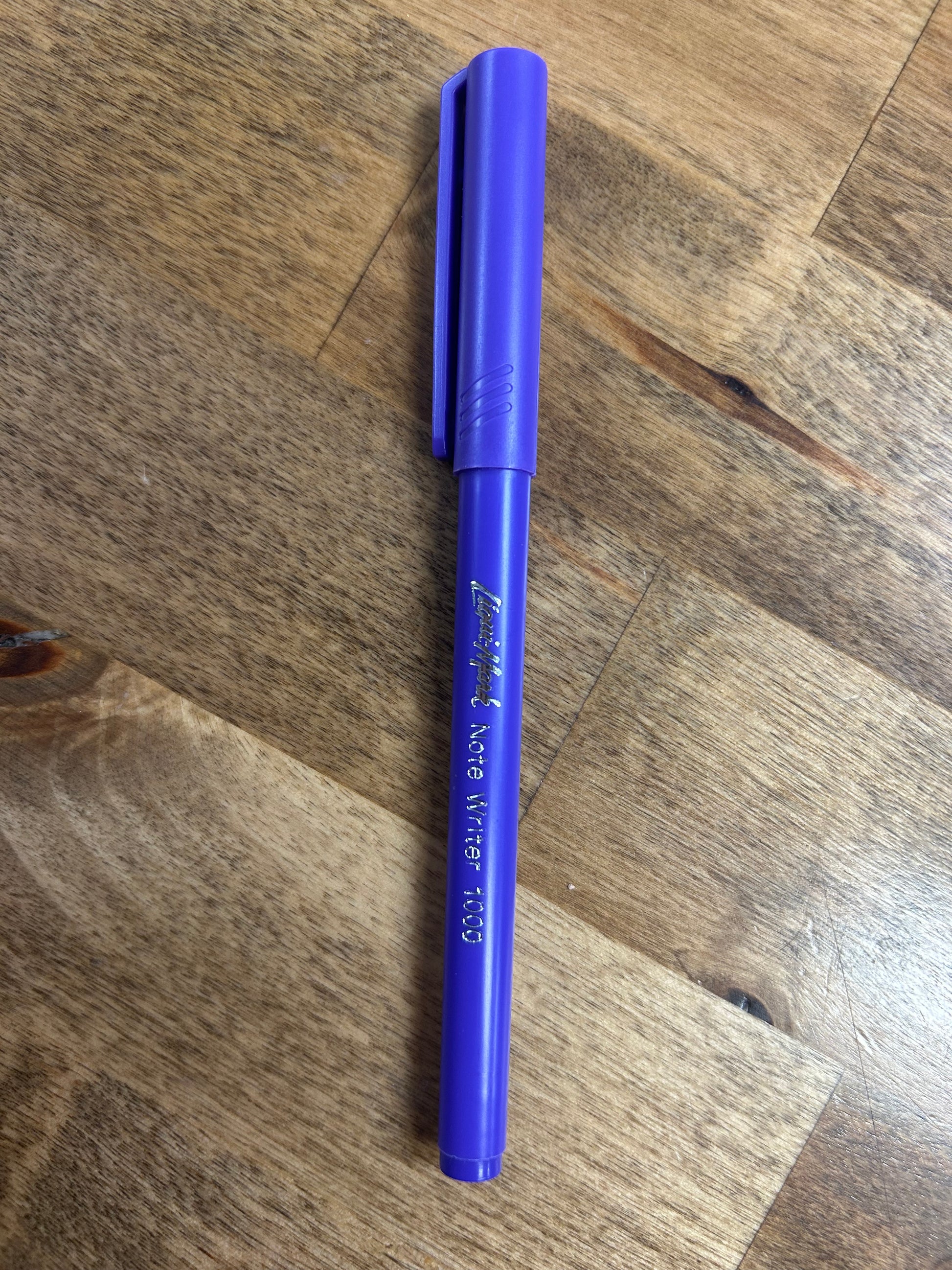 Blue pen on a wooden surface