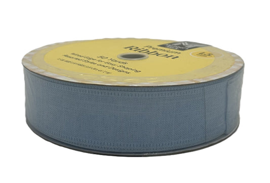 Spool of blue ribbon with a yellow label on a white background
