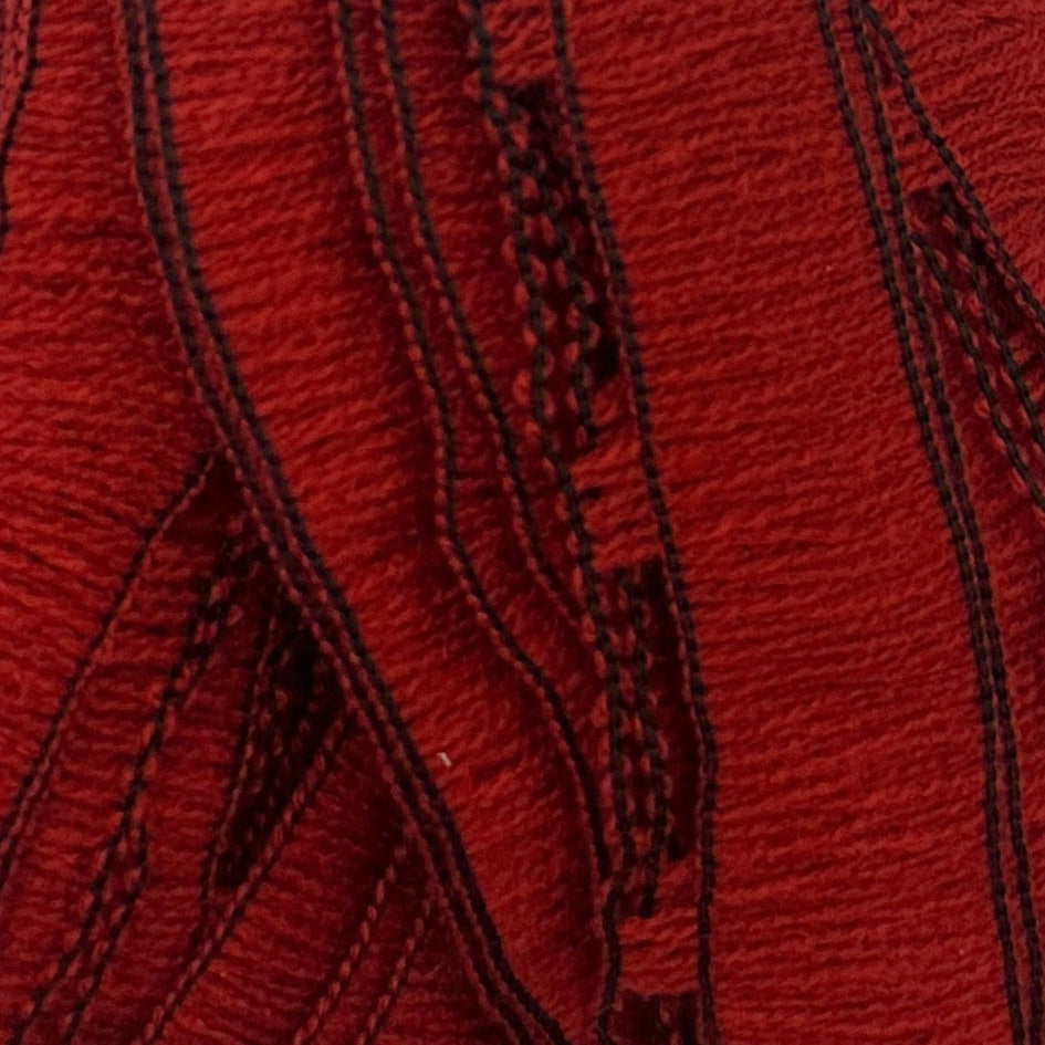 Close-up of red fabric with black stitching