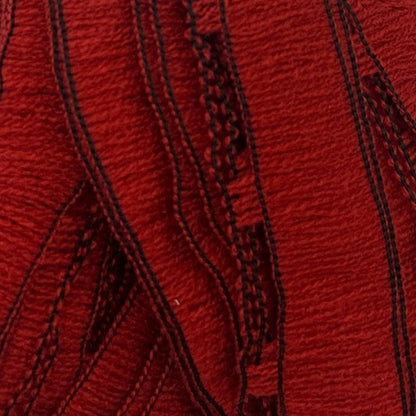 Close-up of red fabric with black stitching