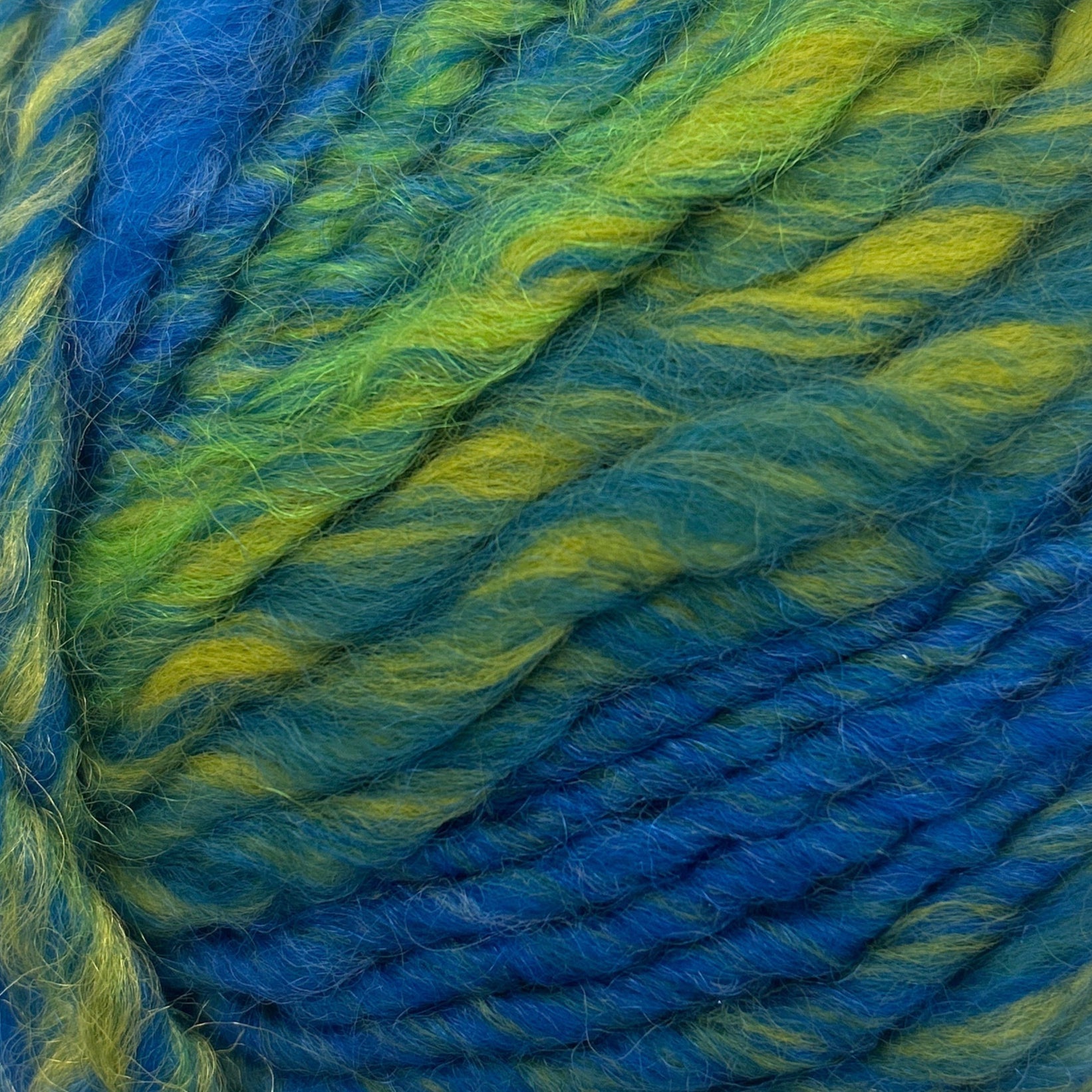 Blue and green skein of yarn on a white background