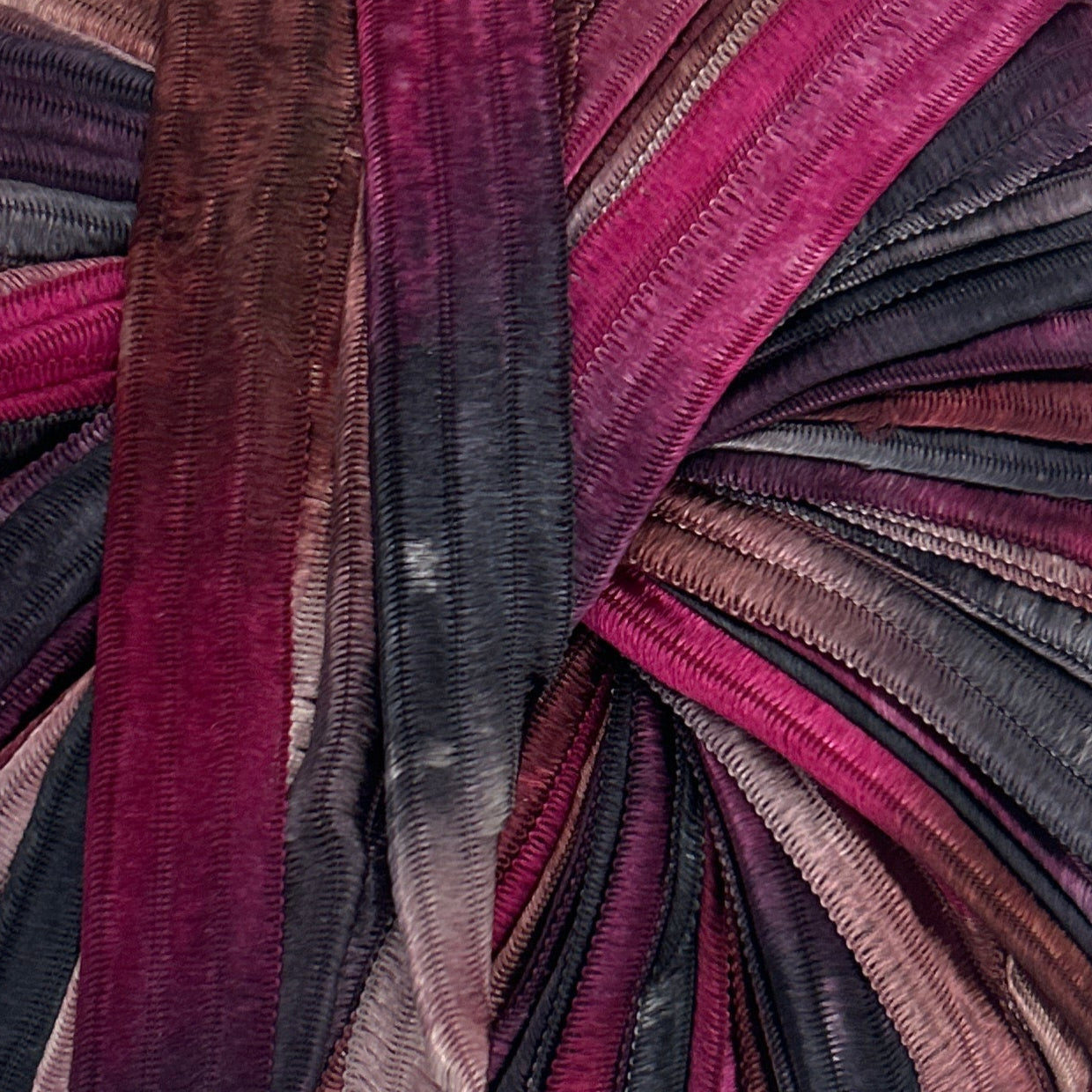 Multicolored striped fabric roll on a white background