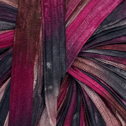 Multicolored striped fabric roll on a white background