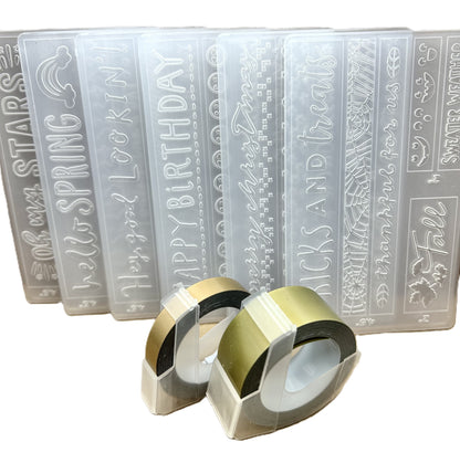 Set of embossing folders with various designs and text, accompanied by two embossing rolls.