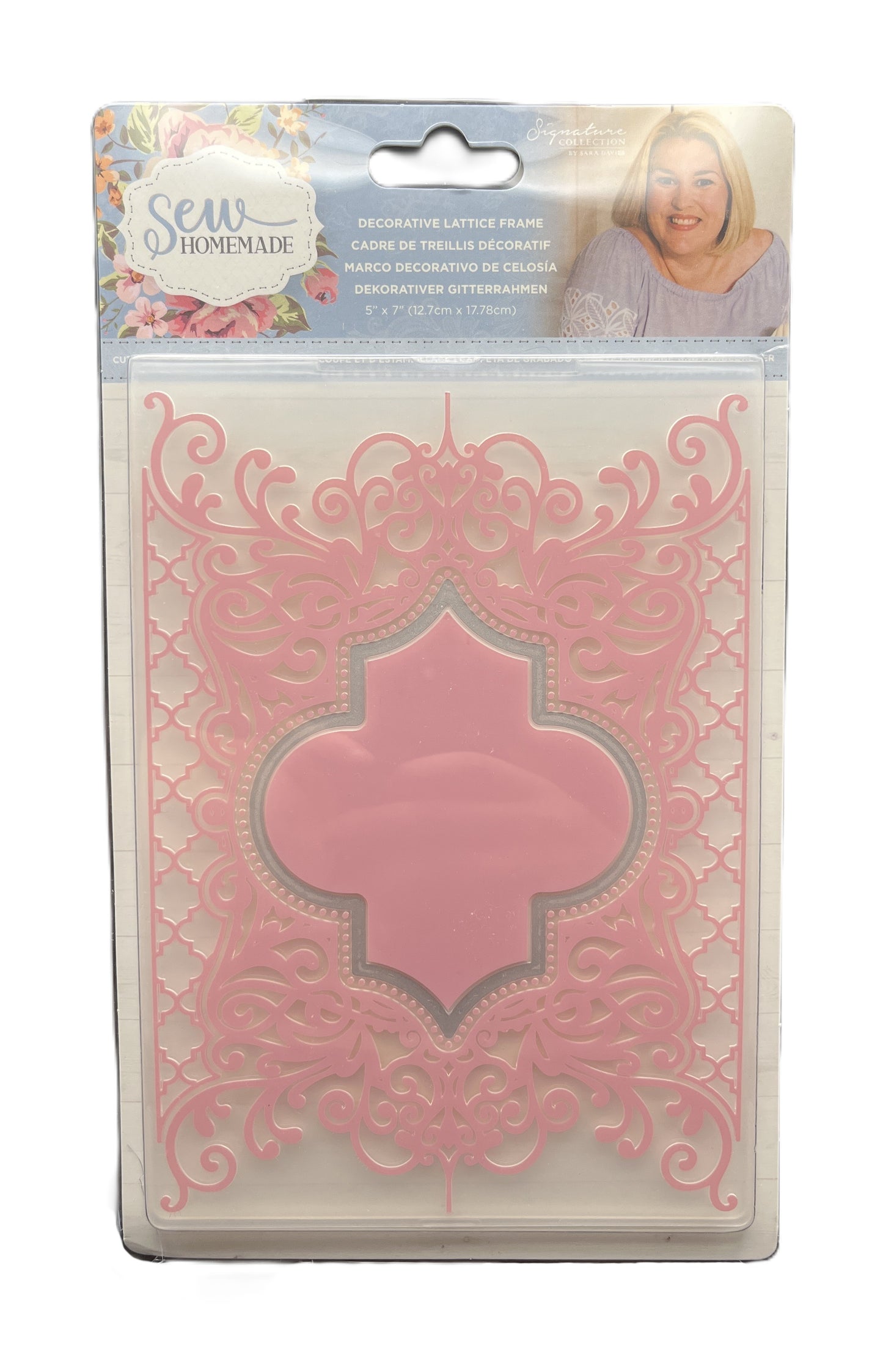 Decorative laser cut paper in packaging with a pink design on a white background