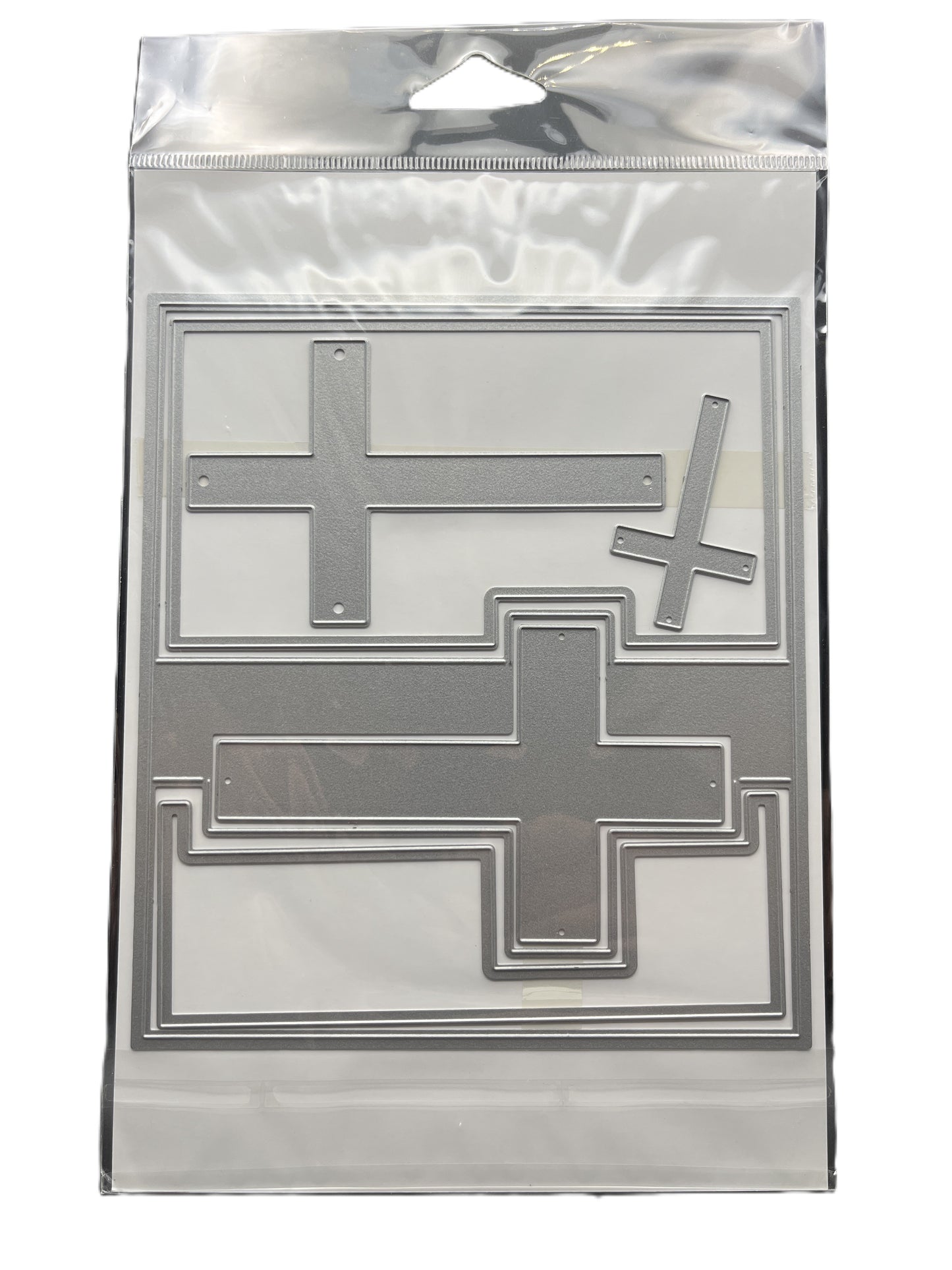 Metallic cross-shaped stamps in a clear plastic packaging on a white background
