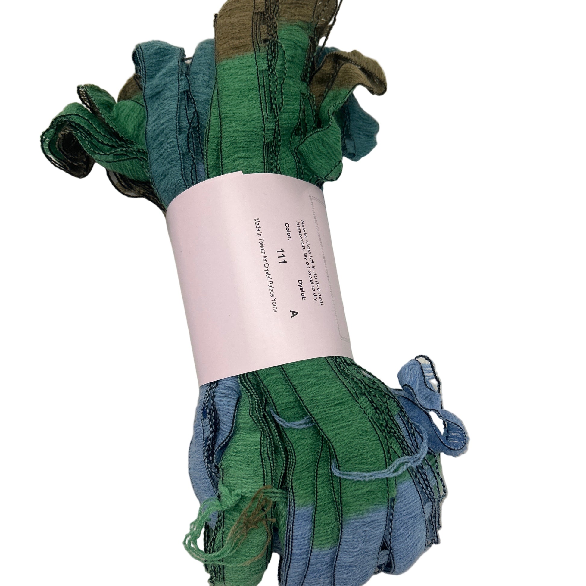 Rolled-up green and blue fabric on a white background