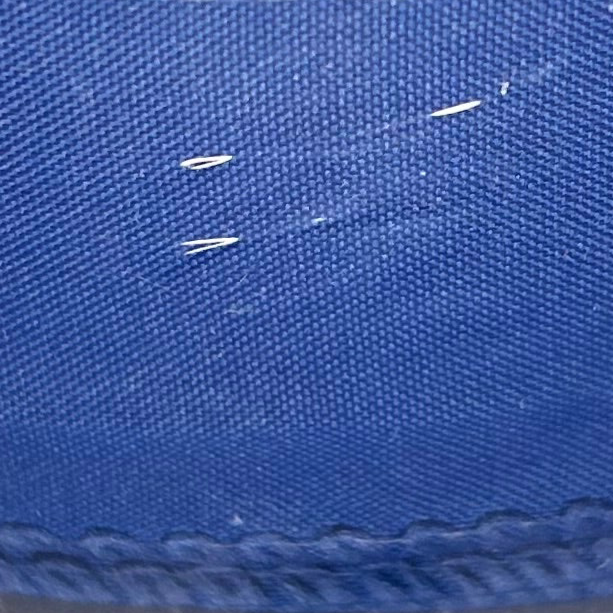Close-up of blue fabric with visible stitching