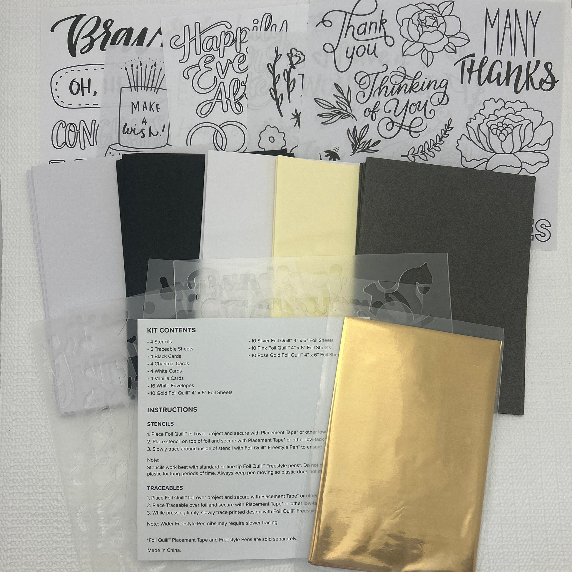 Collection of stationery items including cards and a stamp set on a white surface.