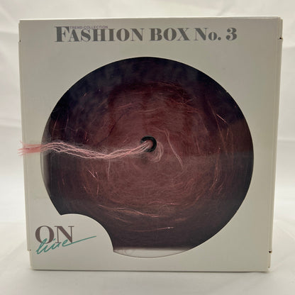 Box with a circular cutout displaying a hair extension, labeled 'Fashion Box No.3'.