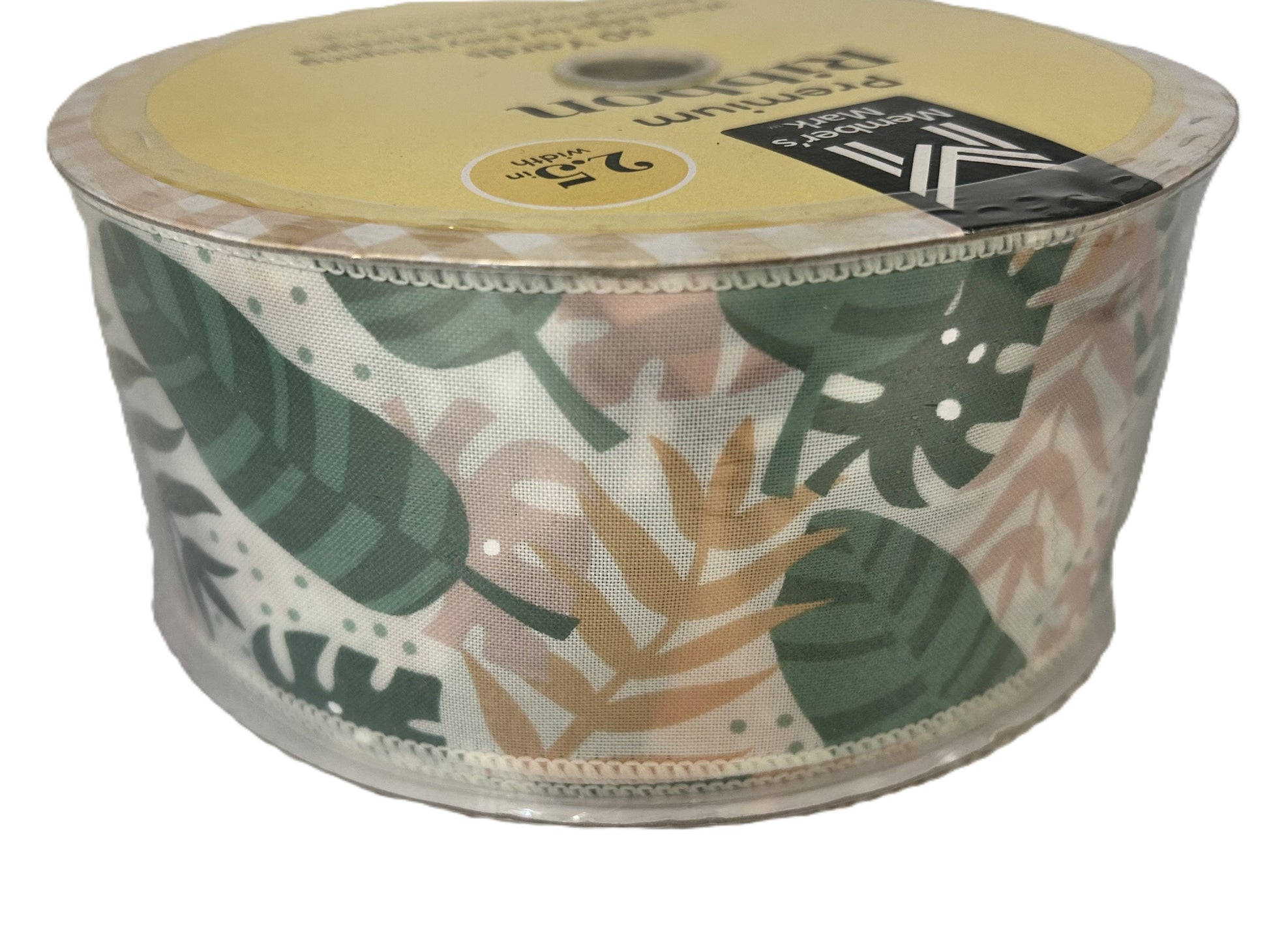 Roll of ribbon with leaf pattern on a white background