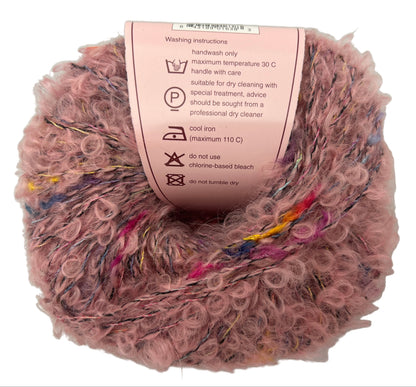 Ball of pink yarn with care label on a white background