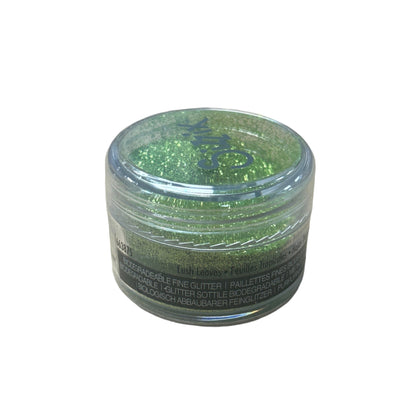 Green glitter in a clear container on a white background