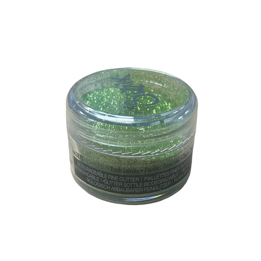Green glitter in a clear container on a white background