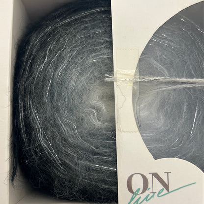Ball of gray yarn in a cardboard box with 'Roz' branding.