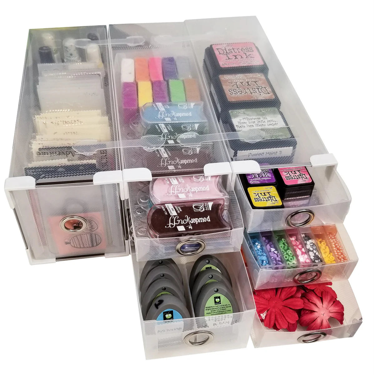 Clear storage box with compartments containing various stationery items on a white background
