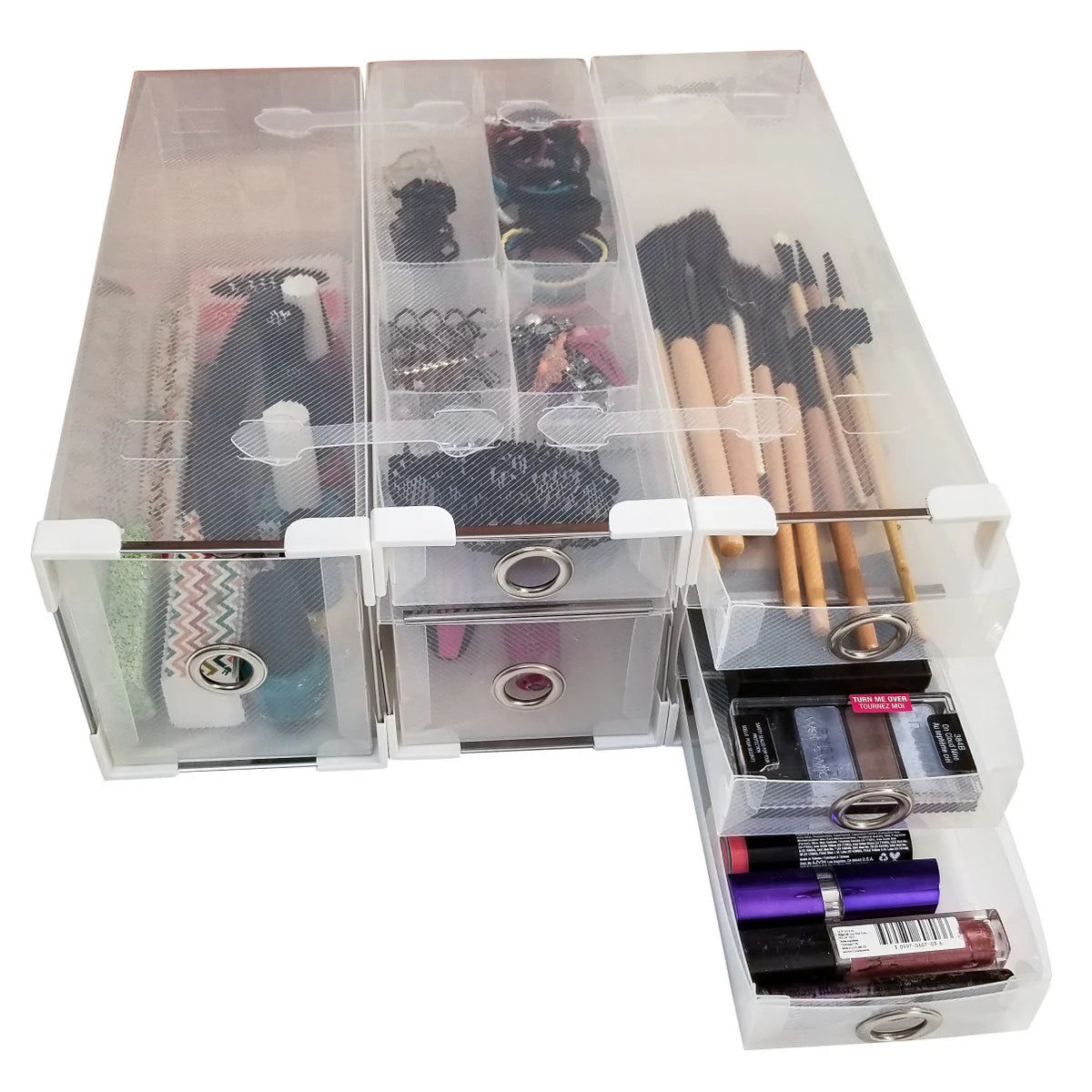 Clear makeup organizer with various cosmetic items on a white background