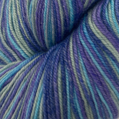Blue and green striped yarn skein on a white background