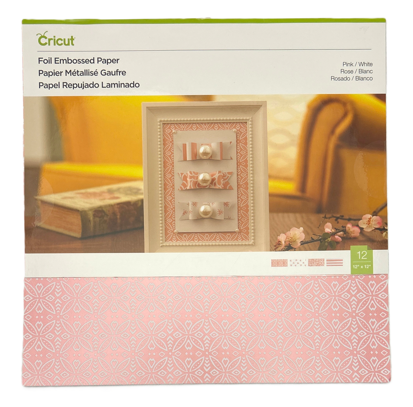 Cricut foil embossed paper packaging with decorative paper and embossing on a blurred background