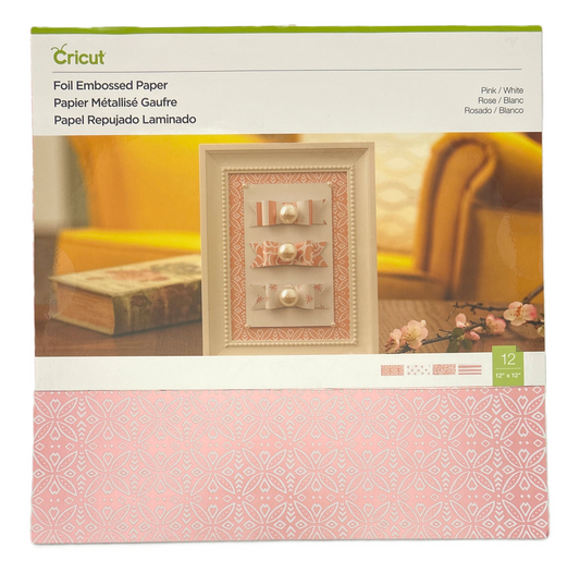 Cricut foil embossed paper packaging with decorative paper and embossing on a blurred background