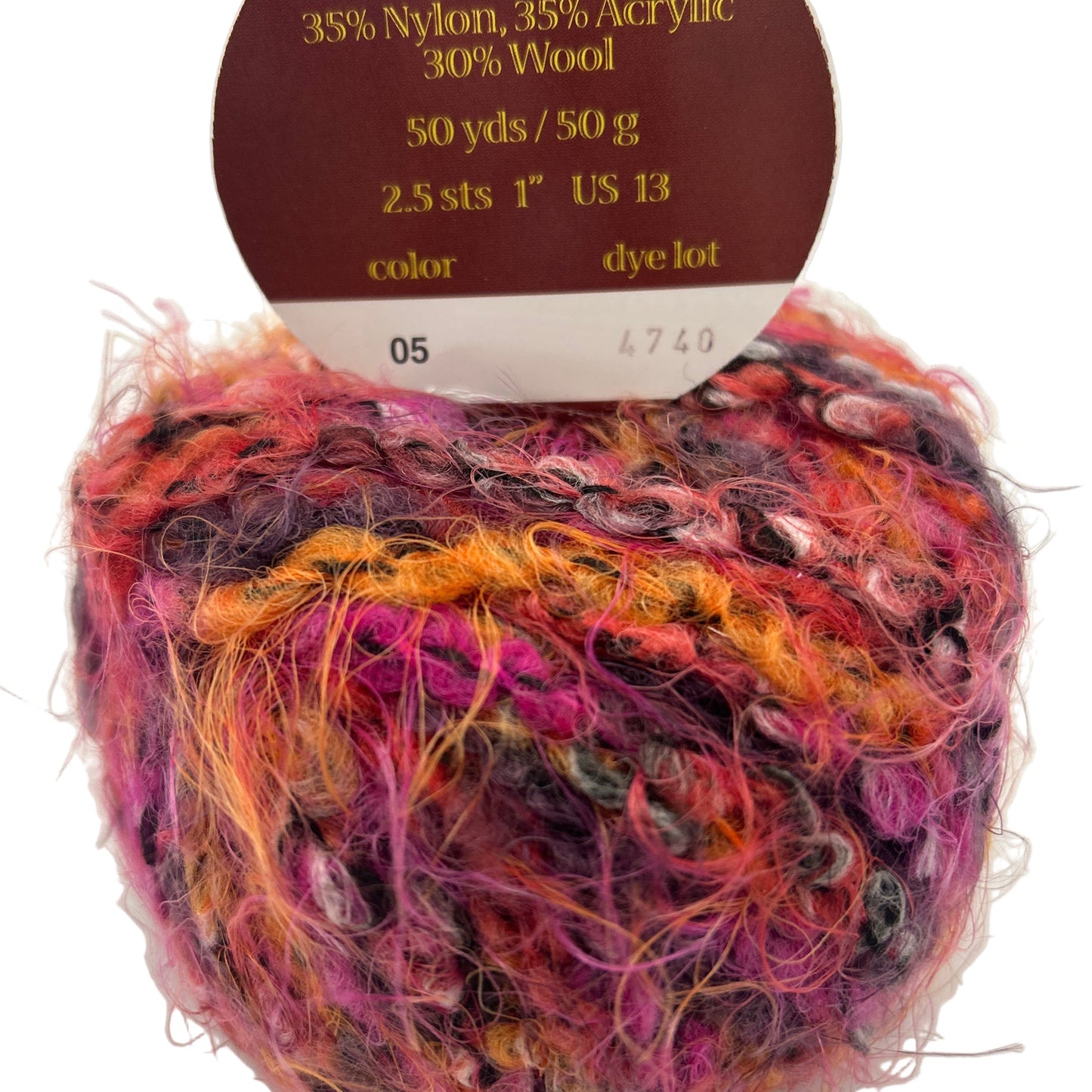 Multicolored yarn ball with label indicating 'made in Italy' and fiber composition on a white background