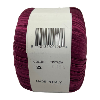 Maroon spool of yarn with a label on a white background