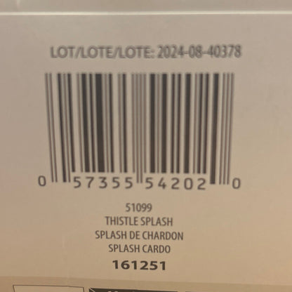 Close-up of a product label with text and a barcode on a wooden surface
