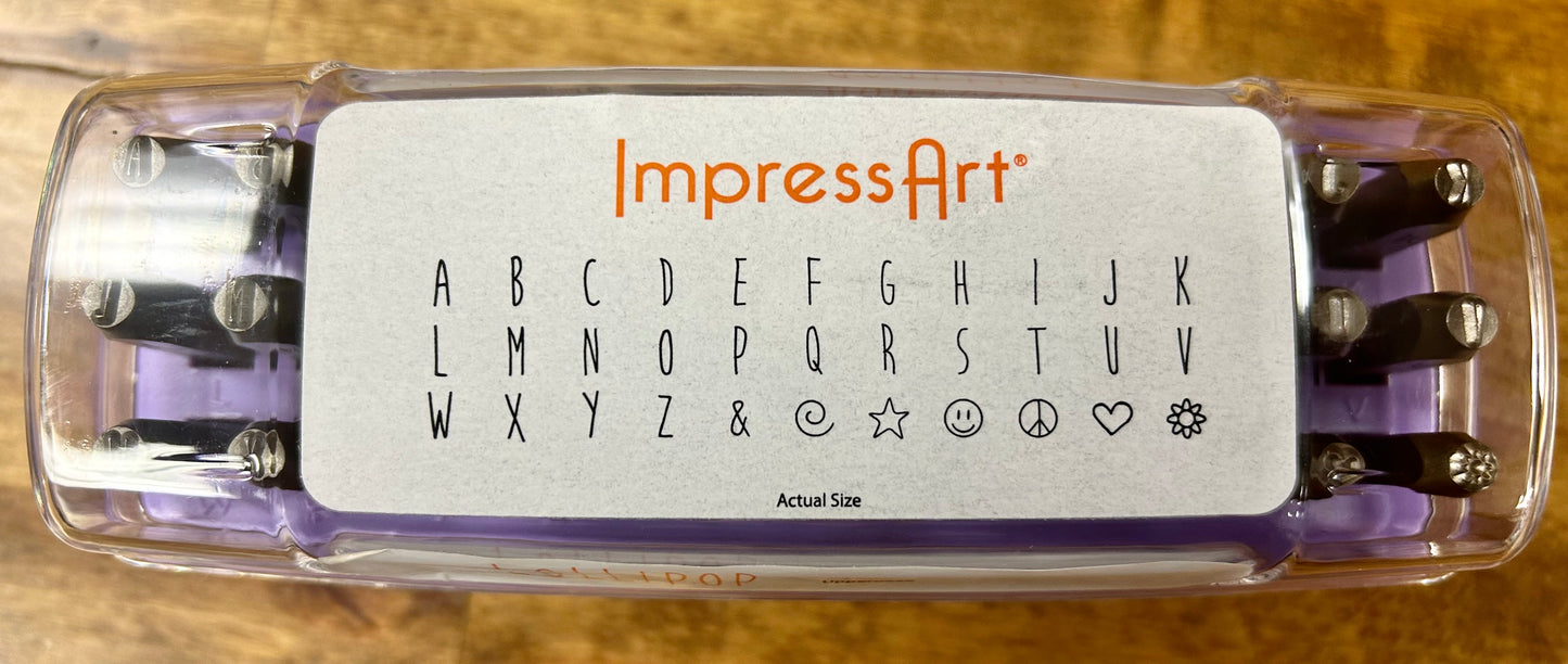 ImpressArt stamp set with alphabet and symbols on a wooden background