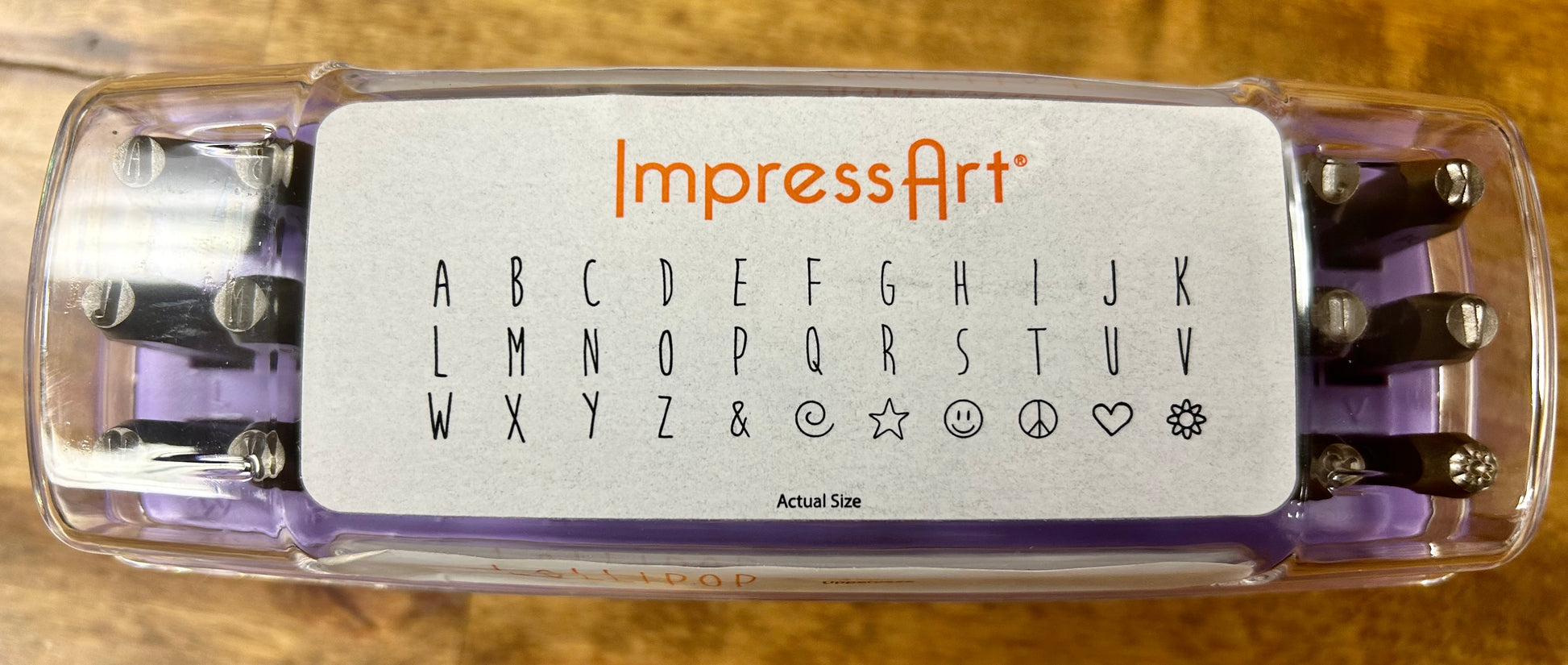 ImpressArt stamp set with alphabet and symbols on a wooden background