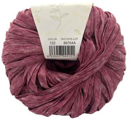 Ball of pink yarn with a label on a white background