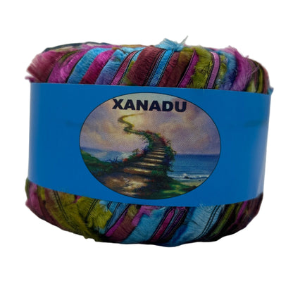 Colorful yarn ball with a blue label featuring 'Xanadu' on a white background