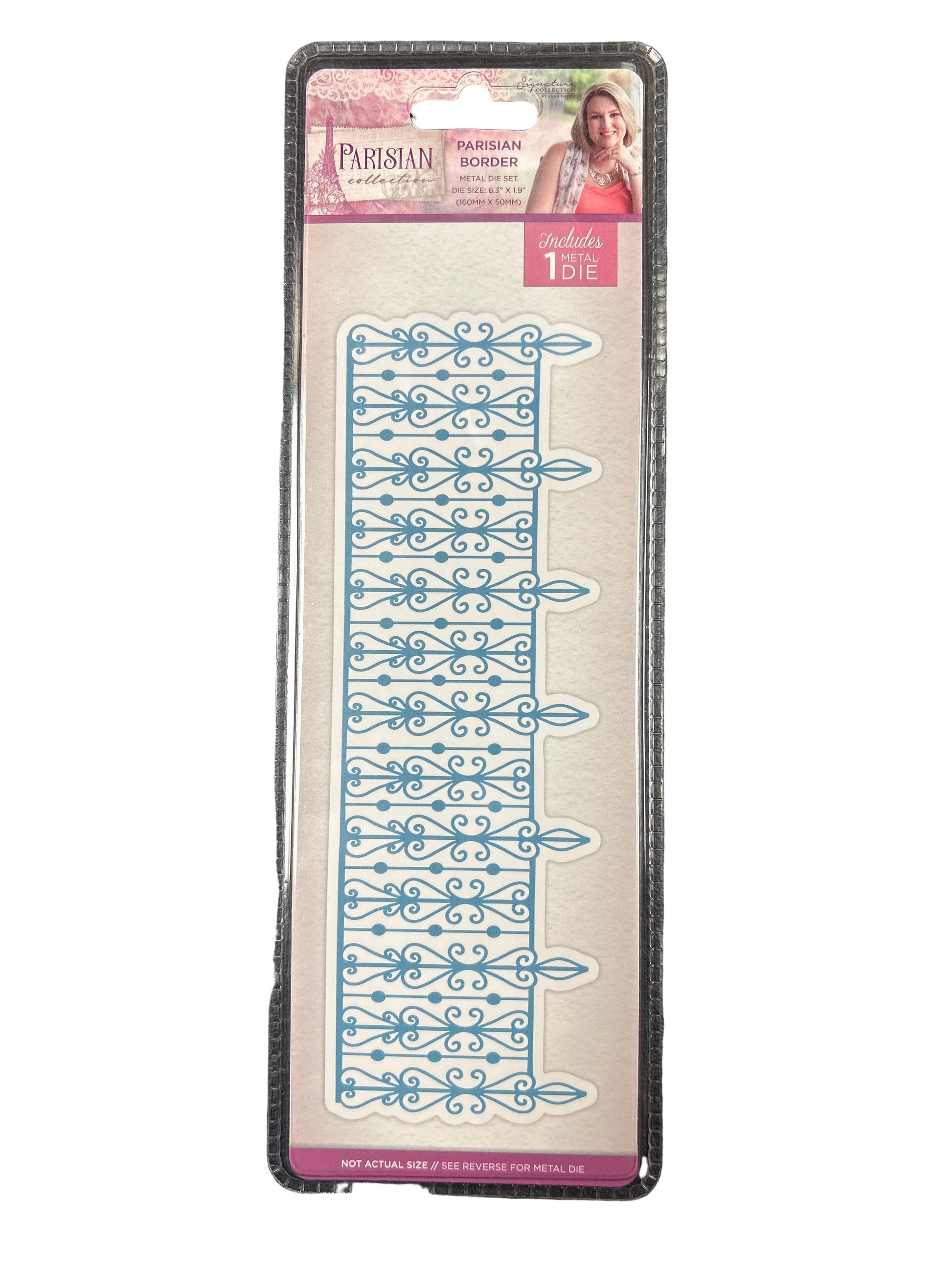 Decorative ruler with blue patterns on a clear plastic card against a dark background