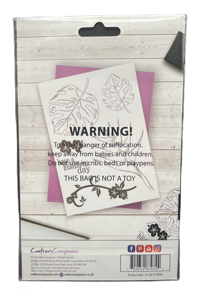Product packaging with warning label and floral design on a wooden surface