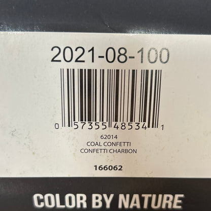 Black yarn ball with a label on a wooden surface
