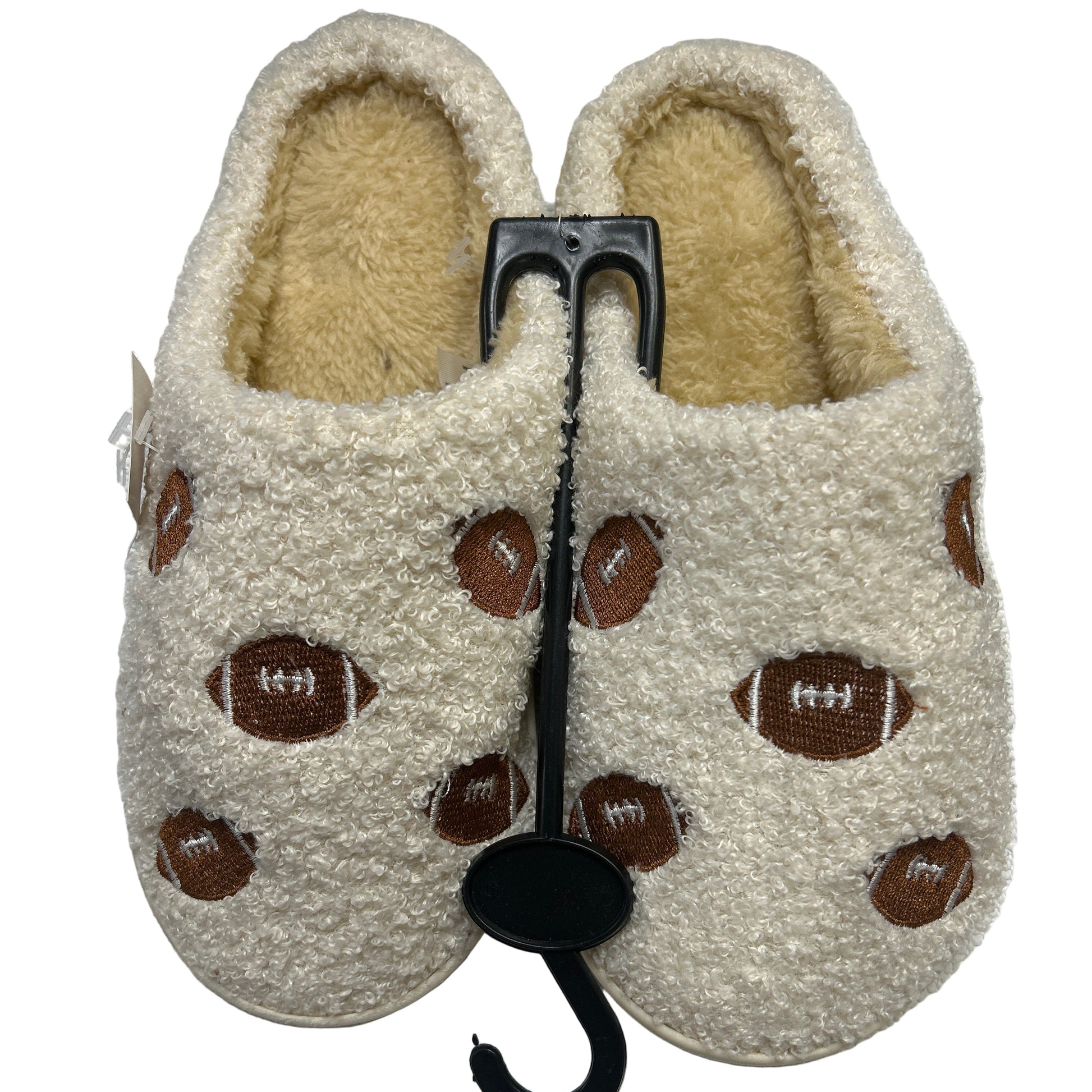 Pair of beige slippers with brown football patterns on a white background