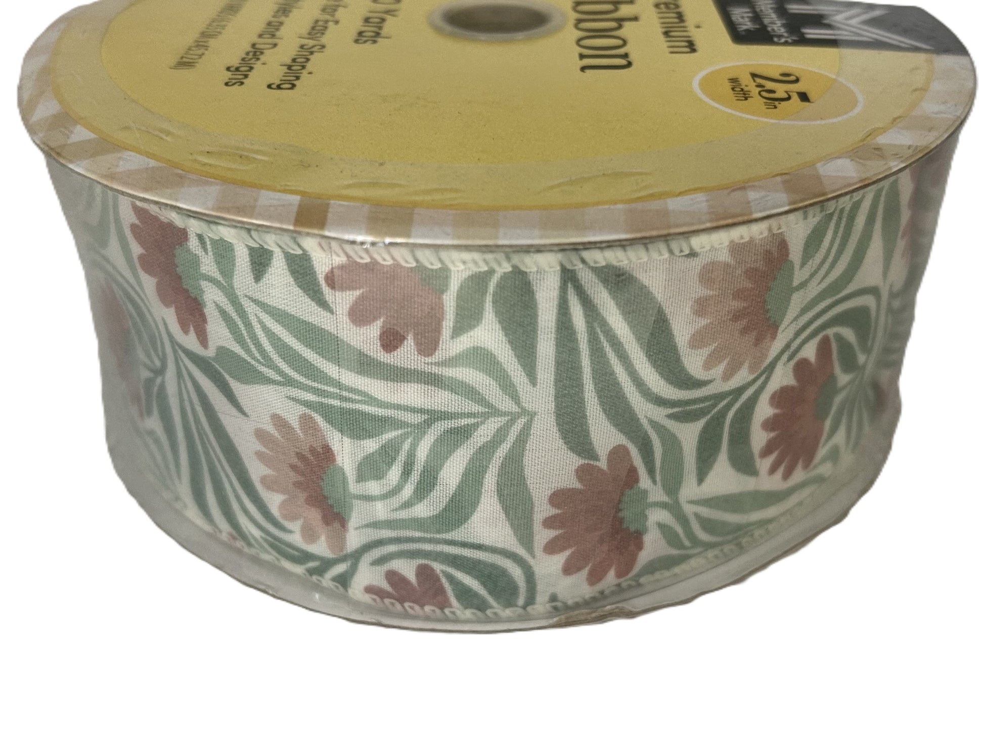 Spool of floral-patterned ribbon with a yellow label on a white background